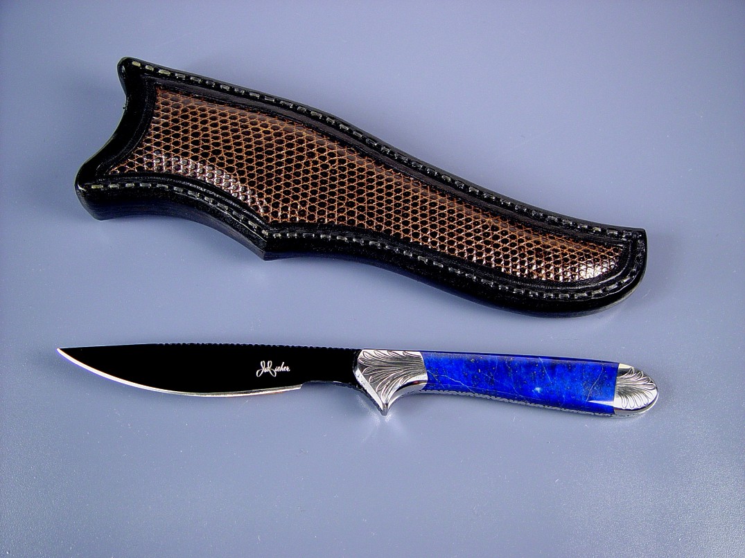 "Clarau" fine handmade knife, obverse side view: blued O-1 tool steel blade, hand-engraved 304 stainless steel bolsters, Lapis Lazulii gemstone handle, lizard skin inlaid in hand-carved leather sheath