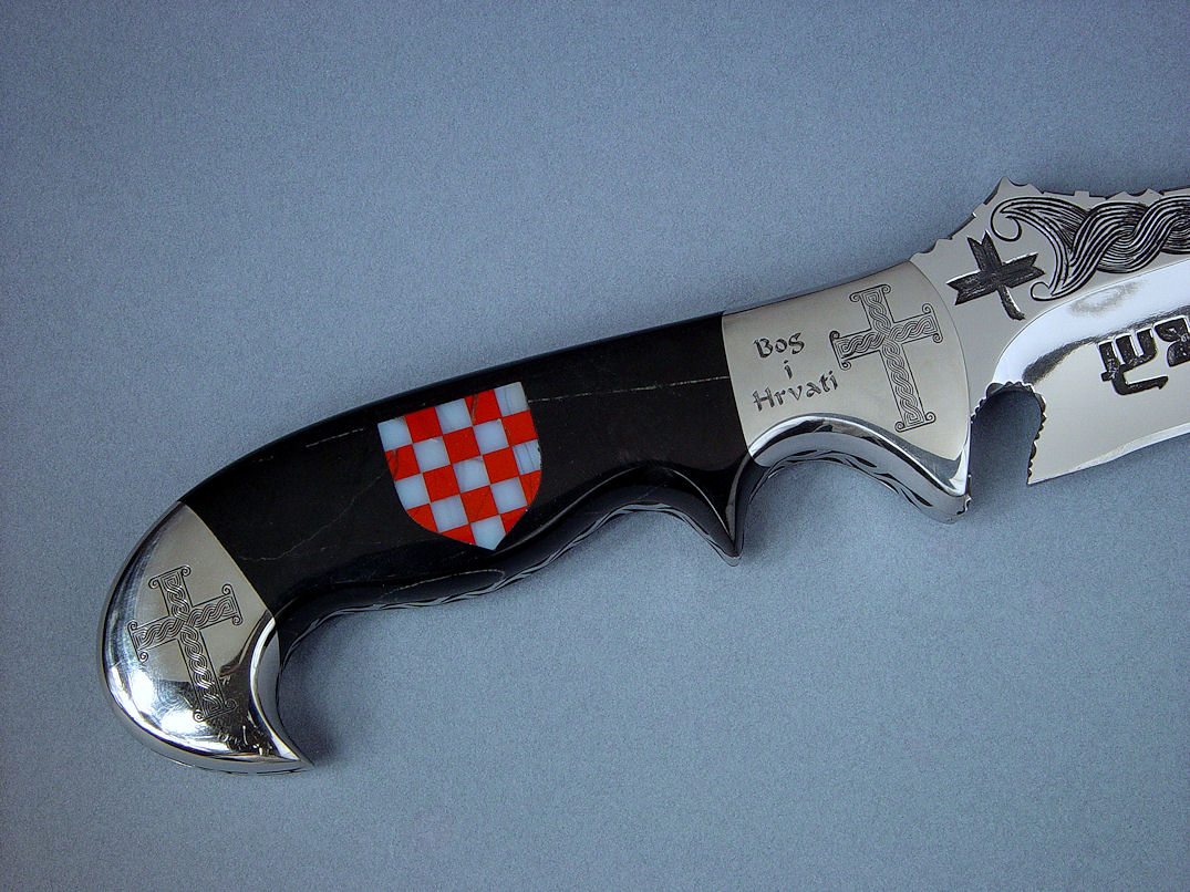 "Duhovni Ratnik" reverse side view. Meticulous engraving of stainess steel blade and bolsters abounds.