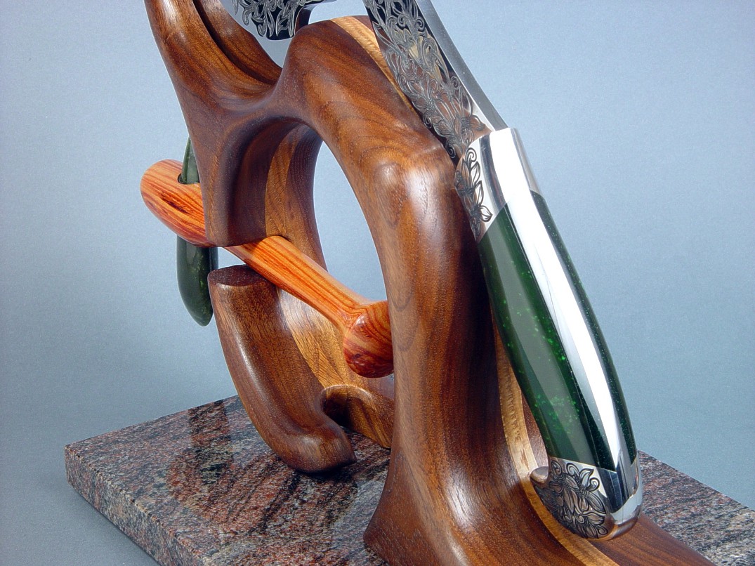 Manaya, petaloid celt position in display stand of walnut, oak, and granite