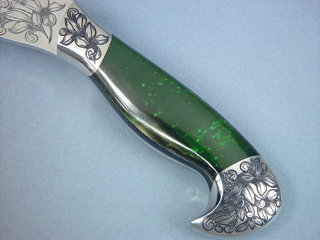 Nephrite jade is one of the toughest minerals on earth. Locked and bedded into hatchet handle of stainless steel.