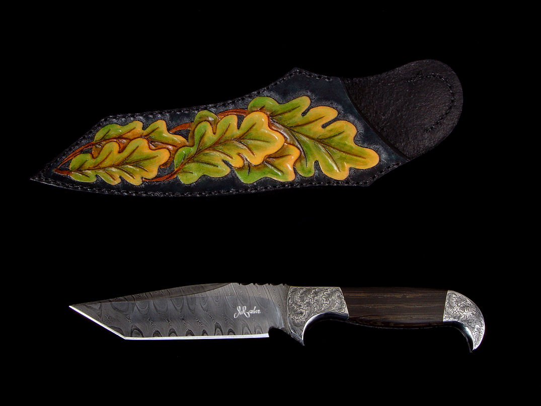 "Morta" obverse side view in twist damascus pattern welded steel (O1 and A36), hand-engraved 304 stainless steel bolsters, Bog Oak mineralized handle, sheath of hand-dyed, hand-carved leather shoulder.