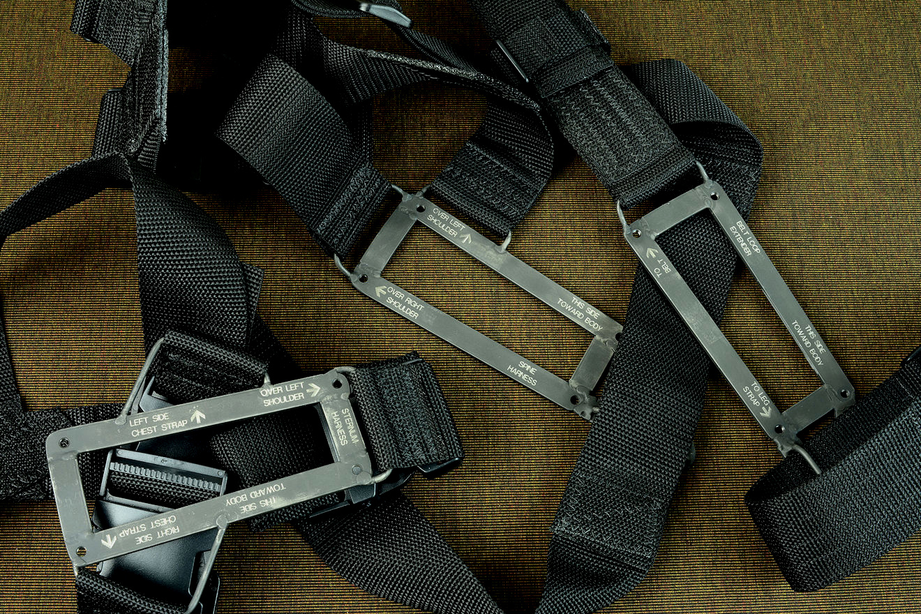 "PJ-CT" black modular sheath wear options: Sternum harness, belt loop extender, and spine harness in black polyethylene, acetyl, and engraved blackened 304 stainless steel