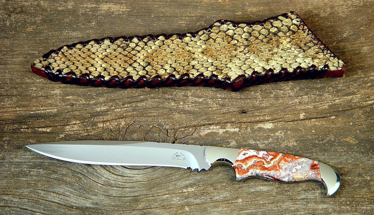"Prairie Falcon" tactical knife, obverse side in 440C high chromium stainless steel blade, 304 stainless steel bolsters, Crazy Lace Agate gemstone handle, Western Diamondback Rattlesnake over laced leather sheath