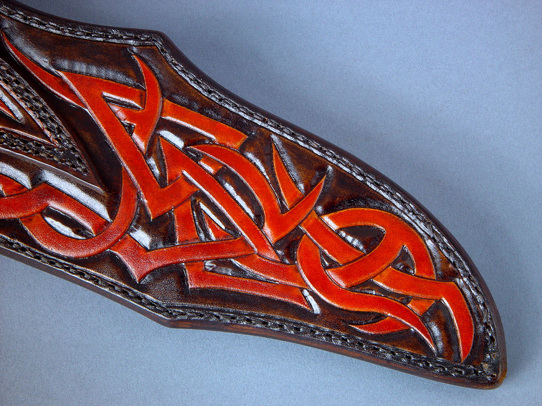 "Tribal" in hand-engraved 440C high chromium stainless steel blade, hand-engraved 304 stainless steel bolsters, Pilbara Picasso Jasper gemstone handle, sheath of hand-carved, hand-dyed leather shoulder, stand of 304 stainless steel, American black walnut, mesquite, lauan hardwoods, engraved black lacquered brass