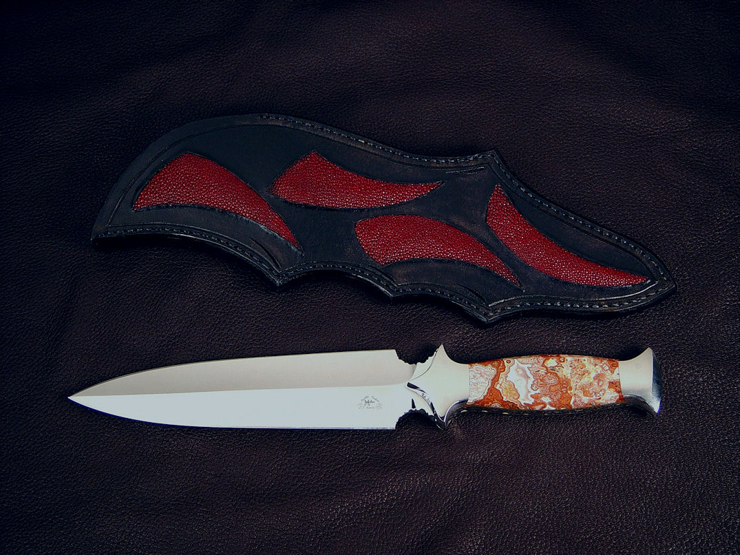 "Troll Magnum" obverse side view in 440C high chromium stainless steel blade, 304 stainless steel bolsters, Crazy Lace Agate gemstone handle, sheath of red rayskin inlaid in hand-carved leather shoulder.