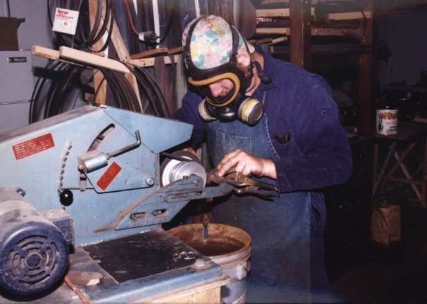 Jay Fisher, working at the belt grinder, profiling blades with a fiberglass reinforced cutoff wheel at 5000 sfpm.