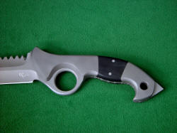 "Ari B'Lilah" obverse side handle view. Bolsters are T2 pure titanium for extreme light weight and corrosion resistance, handle scales are G10 epoxy-fiberglass composite. Large lanyard hole is chamfered, easy to thread and use. Rear talon at butt is tough and useful adjunct