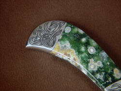 "Bootes ST" reverse side rear bolster engraving detail. Engraving is intersecting leaf blade pattern in stainless steel