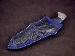 "Chama" sheathed view. Sheath is solid and protective, and matches the gemstone well in black ostrich skin and blue leather shoulder