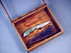 "Durango" open display case detail. Knife and sheath are lightly wedged in holders of Lauan hardwood