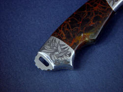 "Grus" reverse side rear bolster engraving detail. engraved bolsters are contoured and finished, rear bolster allows access to milled lanyard slot in knife tang.