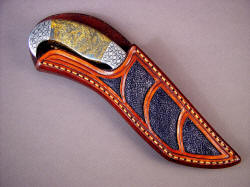 "Iraca" sheathed view. Note sheath is protective of blade and cutting edge, yet displays handle and bolster embellishment. 