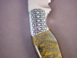 "Iraca" reverse side front bolster engraving detail. Bronzite Hypersthene is a chatoyant, spangled, metallic gemstone.