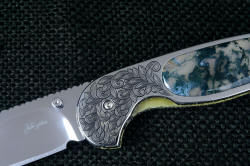 "Izar" linerlock folding knife, 3.7 power enlargement of the obverse side liner engraving in 304 stainless steel