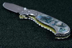 "Izar" linerlock folding knife, handle butt view. Full filework throughout, green-gold permanently anodized titanium alloy springplate