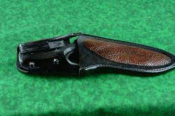 "Kairos" tactical knife, retention method detail with postive locking sheath in leather and bison skin inlay, stainless steel double snap retention