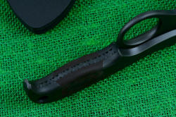 "Kairos" professional counterterrorism tactical knife, close up of inside handle tang, showing filework, contoured finger ring, bolsters, and tapered tang
