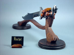 "Kochel" front right view. The llines of the knife and stand work together, looking like a dark forest beast 