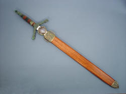 "Lycaon" scabbard and sheathed view showing the lauan exotic hardwood scabbard with cast bronze chape, handmade