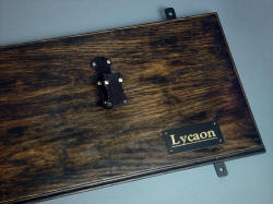 "Lycaon" backboard/mount detail showing strong steel hangers solidly bolted to the backboard to reliably secure sharp broadsword, with engraved brass lacquered nameplate