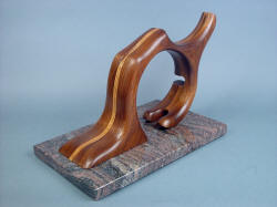 "Manaya" sculptural stand. Red Oak spine in black walnut holds blade, edge of hatchet