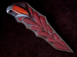 "Mercator" sheathed view. Sheath is deep an protective, while displaying the handle in high-backed arrangement. Inlays are red rayskin and are very tough and hard. There are 12 inlays on the sheath front.