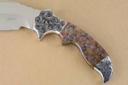"Orion" obverse side handle view. curves of handle and grip are echoed in hand-engraving of bolsters