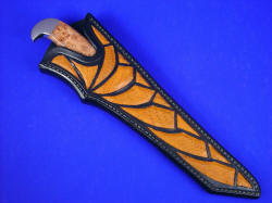 "PJ" sheathed view. Note carved mouth of sheath to accent handle material, and numerous inlays of Emu skin in hand-carved leather