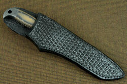 "PJLT" sheathed view, leather sheath. Wearer is protected from blade with heavy welts, handle is accessible and fast to unsheath