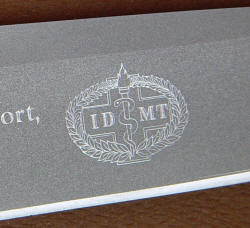 "PJ" reverse side IDMT crest engraving details on bead blasted, hollow ground high chromium stainless tool steel blade