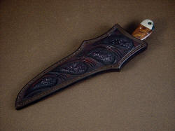 "Sanchez" sheathed view. Sheath is deep, protective and nicely carved and tooled