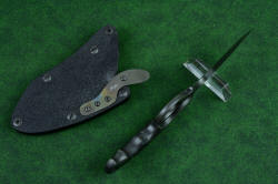 "Skeg" tactical, counterterrorism professional knife, inside handle tang view illustrating the finger grooves, elliptical finger ring, and placement of the forward bolster