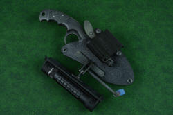 "Skeg" tactical, counterterrorism professional knife, shown with HULA extended away from sheath, illustrating the ball joint mechanism and the pinch screw lock arrangement. Also seen is the LIMA flat against the sheath front