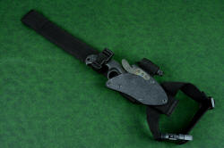 "Skeg" tactical, counterterrorism professional knife, EXBLX (Extended Length Belt Loop Extender) attached. This allows the knife and sheath to hang from the belt while being secured just above the knee on the outside of the leg like a drop holster