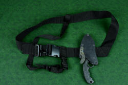 "Skeg" tactical, counterterrorism professional knife, attached to sternum harness. Harness is strapped around torso and over shoulder, placing knife and sheath over sternum, handle down
