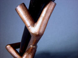 "Tharsis Intense" knife sheath stand detail shows warm color of cast bronze. Form is solid bronze, cast in one piece.