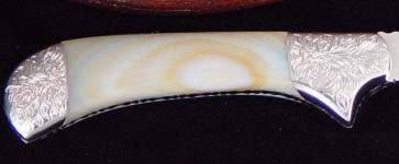 White geodic agate with hand-engraved stainless steel bolsters