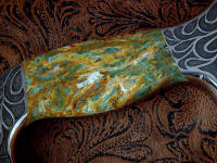 Plasma agate has green agate with bits of red and gold veining, a striking and complex gemstone
