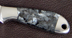 Larvikite has bright flashes of silvery blue-gray colorand is a coarse-grined augite syenite