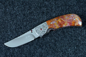"Bellatrix" custom folding knife, obverse side view in T3 deep cryogenically treated ATS-34 high molybdenum martensitic stainless steel blade, hand-engraved 304 stainless steel bolsters, differerentially anodized 6AL4V titanium liners, Roostertail Agate gemstone handle, 304 stainless steel fasteners with garnet faceted gemstones
