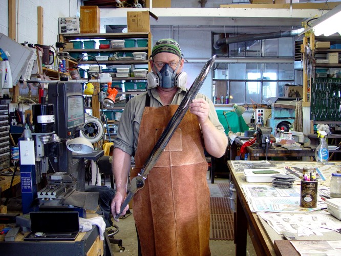 Jay Fisher with mirror finished hollow ground sword blade. Respirator and heavy protection is required in this job!