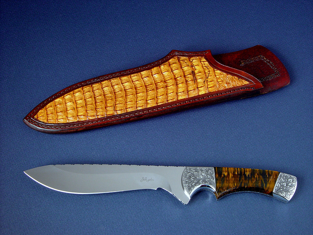 "Golden Eagle" obverse side view in CPM154CM high molybdenum powder metal technology tool steeel blade, hand-engraved 304 stainless steel bolsters, Bicolored Tiger Eye gemstone handle, Caiman skin inlaid in hand-carved leather sheath