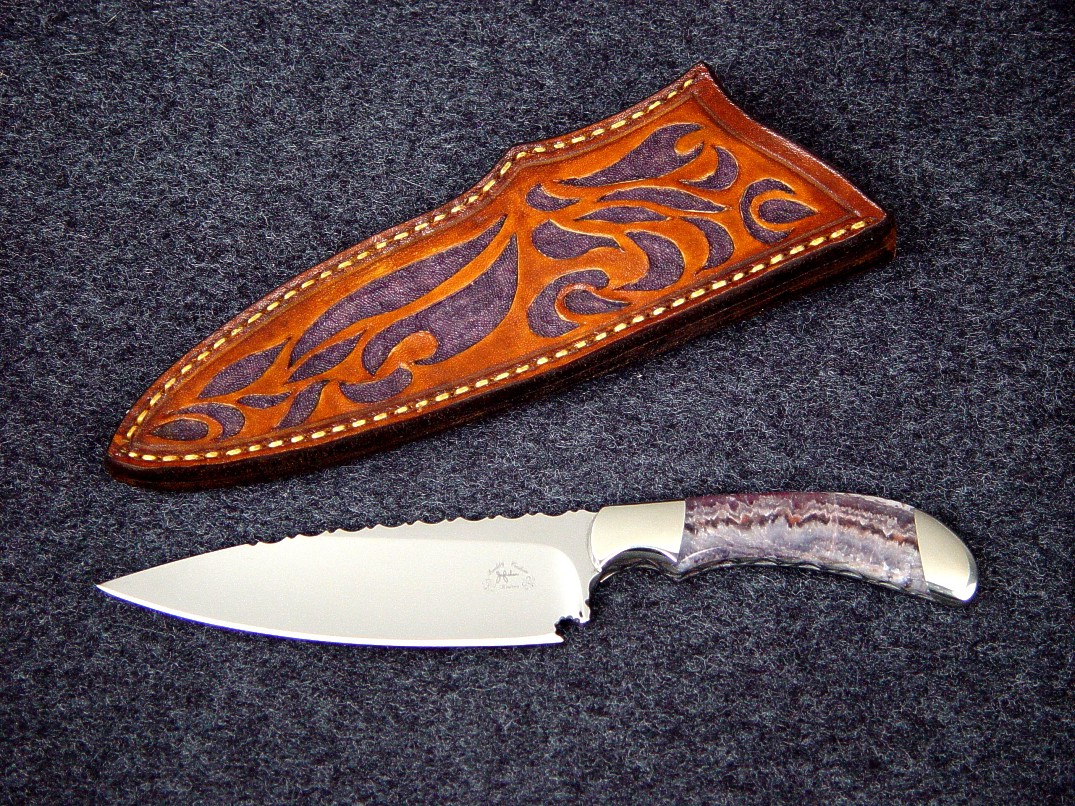 "La Cocina" chef's knife, obverse side view in 440C high chromium stainless steel blade, 304 stainless steel bolsters, Lace Amethyst gemstone handle, hand-carved and tooled leather sheath
