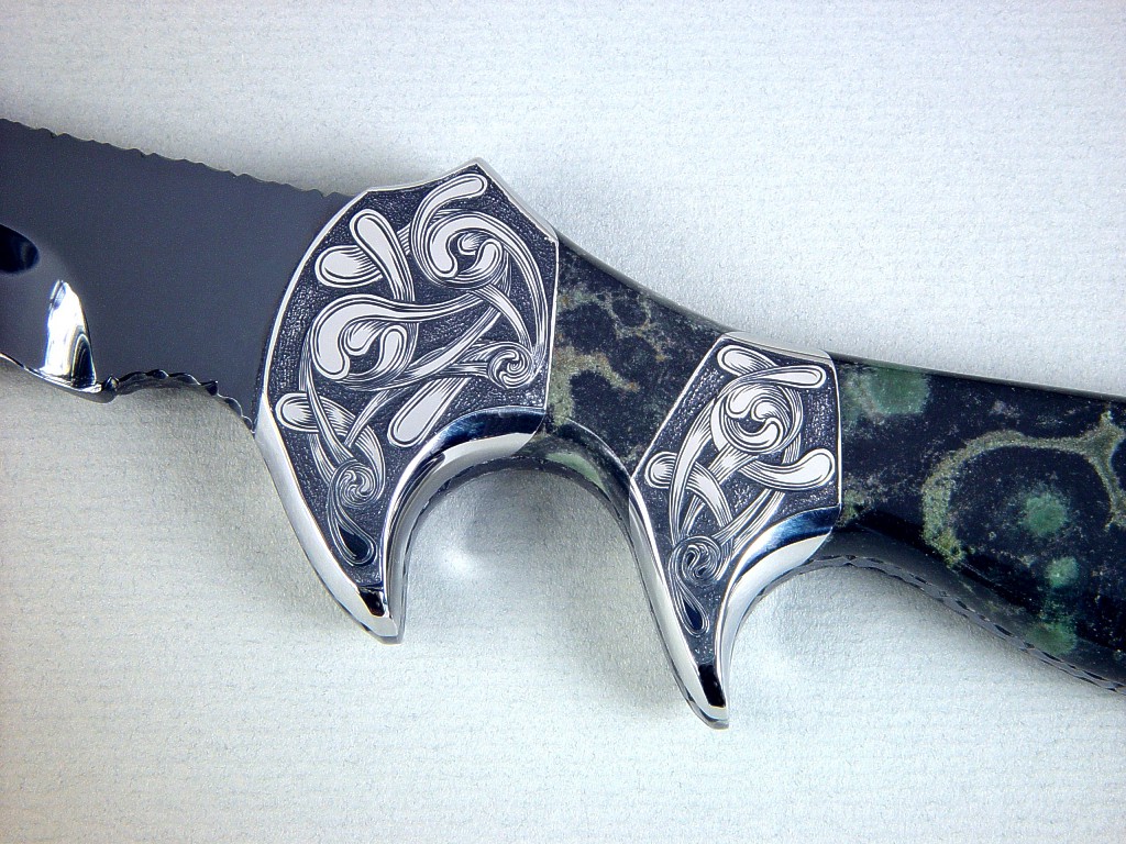 "Ladron" obverse side view in mirror polished and hot blued O1 high carbon tungsten-vanadium tool steel blade, hand-engraved 304 stainless steel bolsters, Nebula Stone gemstone handle, black stingray skin inlaid in hand-carved leather sheath