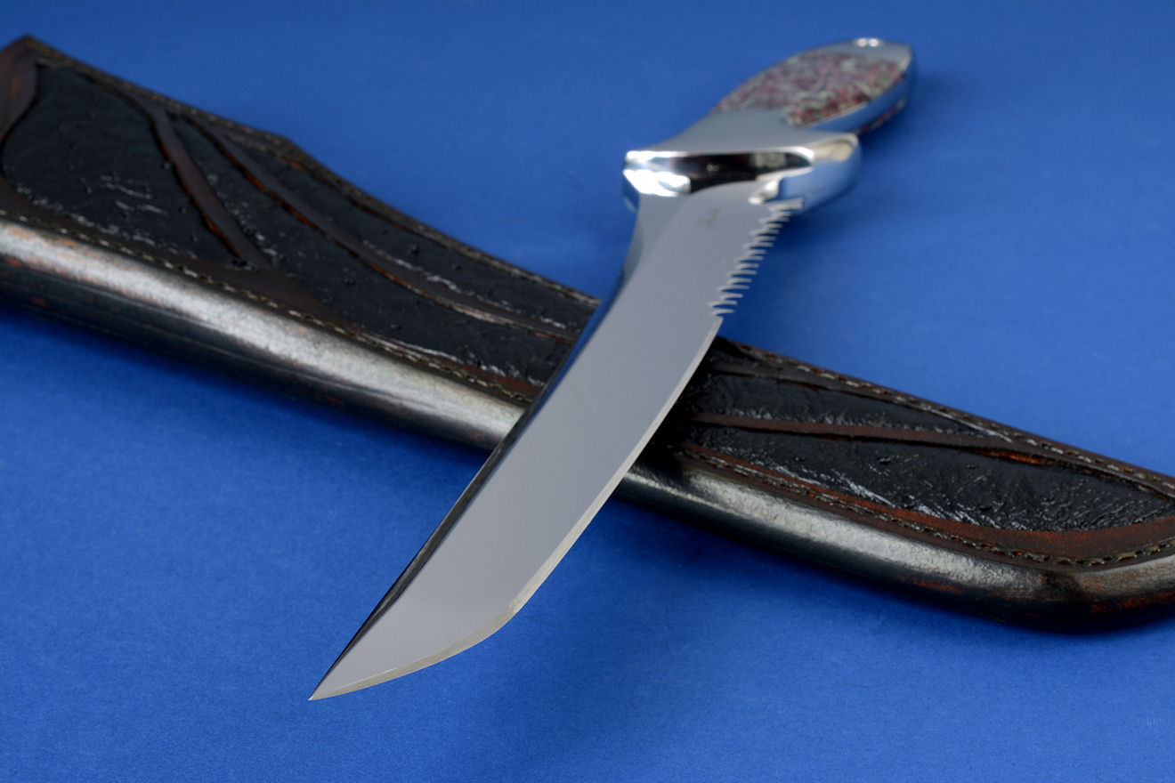 "Taibhse" point detail in CPM154CM high molybdenum powder metal technology stainless steel blade, 304 stainless steel bolsters, Eudialite gemstone handle, hand-carved leather sheath inlaid with Emu skin