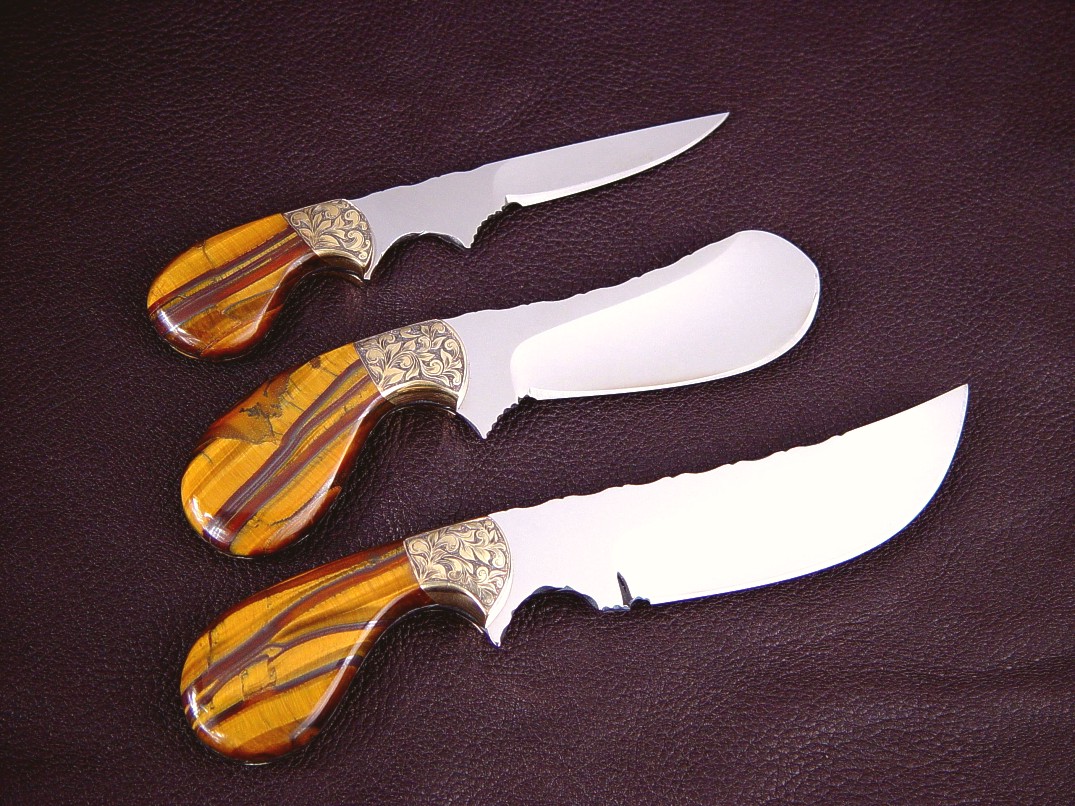 "Trophy Game Set" reverse side view in D2 extremely high carbon die steel blades, hand-engraved brass bolsters, Tiger Eye Gemstone handles: field dressing, skinning, caping knives