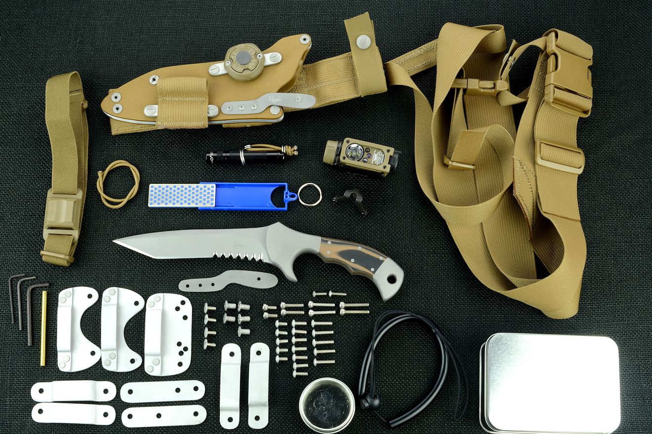 "Uvhash" tactical combat knife, obverse side view with accessories: tension-locking sheath, Ultimate Belt Loop Extender, sharpener, Lamp independent mount assembly with Maglite solitaire, Streamlight Sidewinder Compact II flashlight, lanyards, hardware, variable mounting straps and clamps, sternum harness, hardware