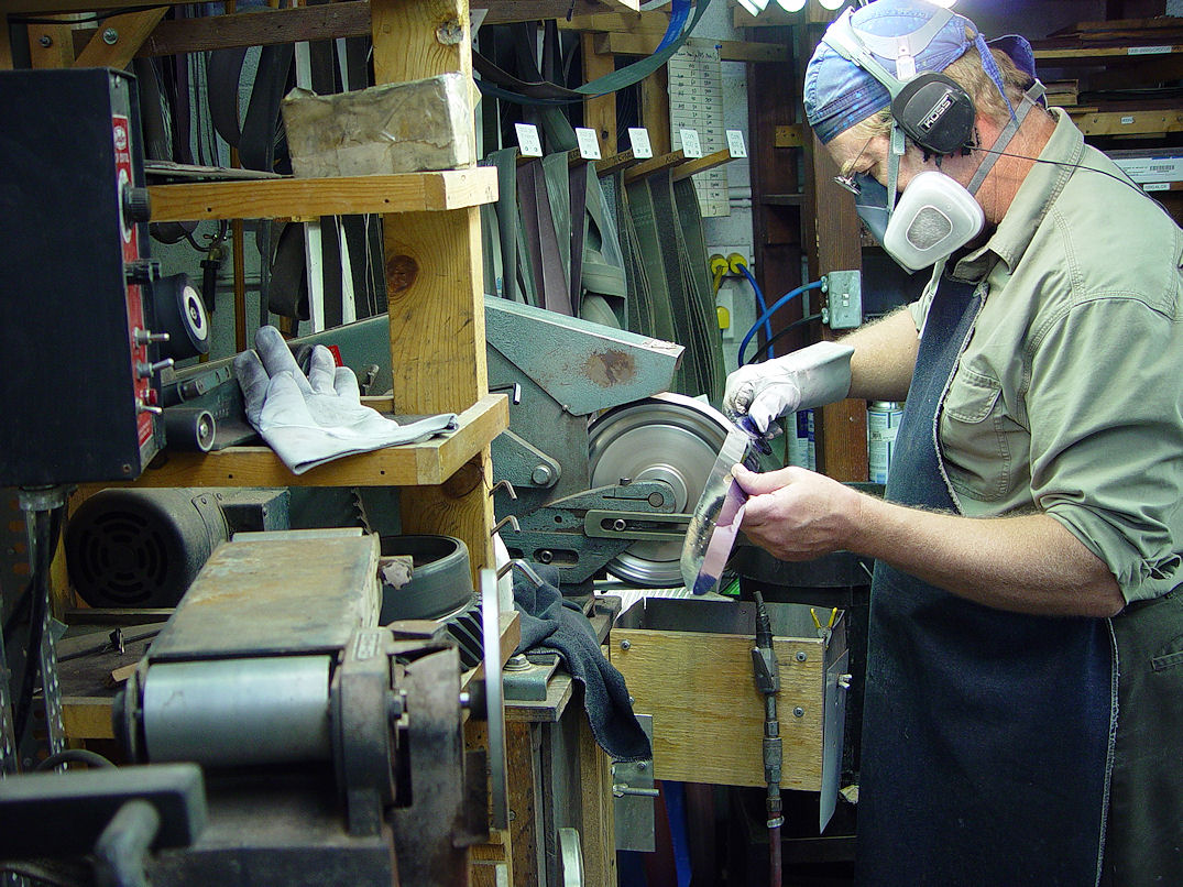 Jay Fisher hollow grinding a large broadsword offhand to mirror polish