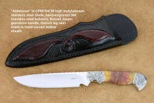 "Aldebaran" obverse side view in CPM154CM high molybdenum powder metal technology stainless steel blade, hand-engraved 304 stainless steel bolsters, Sunset Jasper gemstone  handle, hand-carved leather sheath inlaid with ostrich leg skin