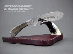 "The Cattleman" in etched ATS-34 high molybdenum stainless steel blade, hand-engraved 304 stainless steel bolsters, Petrified wood jasper gemstone handle, base of polished cow horn, amaranth hardwood